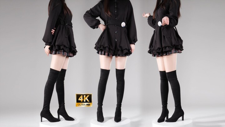 Sepatu bot hak tinggi di atas lutut warna hitam yang dicoba untuk pertama kalinya