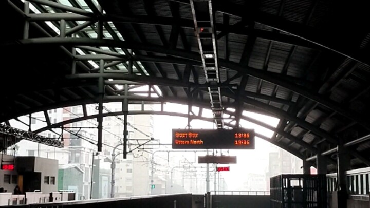 Dhaka Metro Rail Station. It is raining outside. You can hear the sound of the rain drops falling on