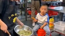 Chinese woman and her son work at restaurant in China. Her son help her, he hard work.