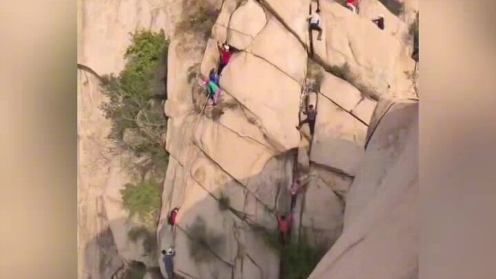 Beijing’s Phoenix Ridge Great Cliff: a group of elderly people are rock climbing outdoors without an