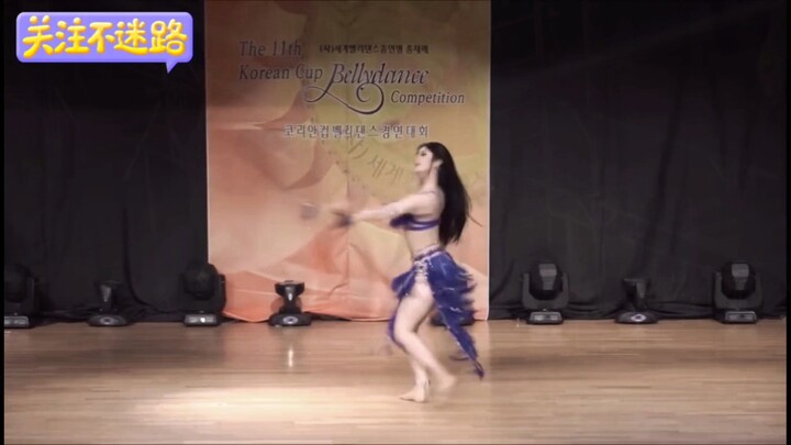 Oriental snake dance, fair skin, alluring figure on full display—belly dance!