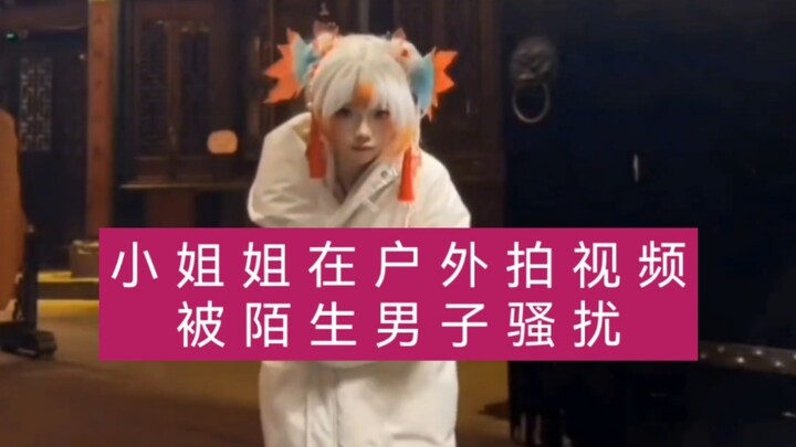 A cosplayer gets harassed by a stranger while filming outdoors.