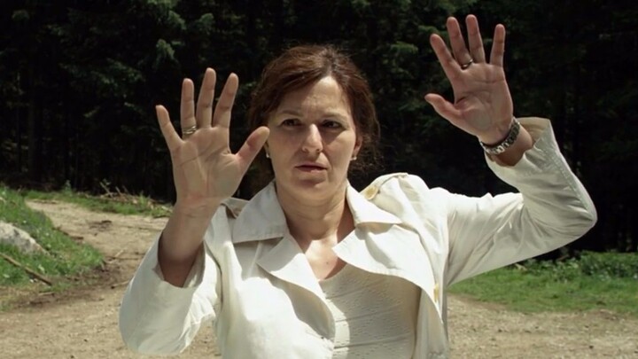 A woman walking in the wilderness suddenly finds herself enclosed by a transparent wall—outside the 