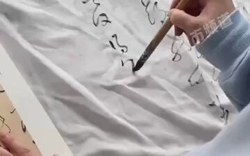 Woman shows off her calligraphy on the curtains…