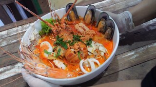 Night market food tour in Bangkok, Thailand: fried snacks, seafood tom yum, and stir-fried yogurt.