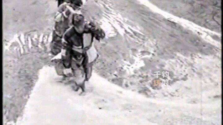 A donkey toils on the mountain path, a man struggles through the rapids—three mountains weigh down o