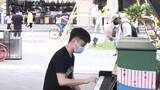 A man covers "Megalovania" with piano in the street
