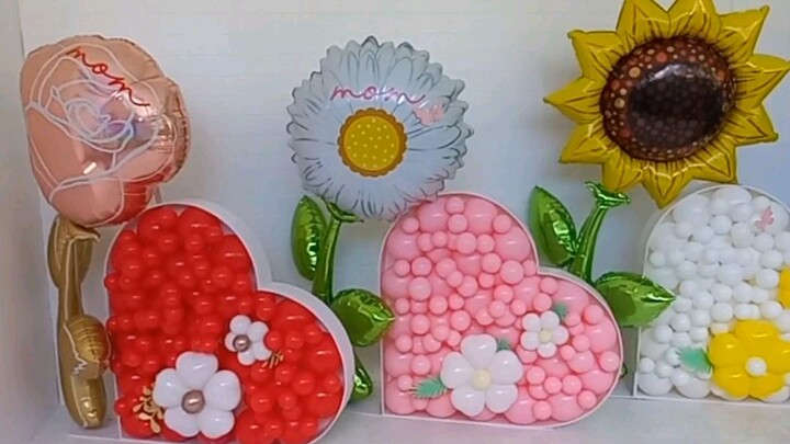 heart balloons in red,pink,and white /flowers.