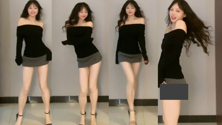 23～iu She’s walking over, wearing a sweater and a skirt.