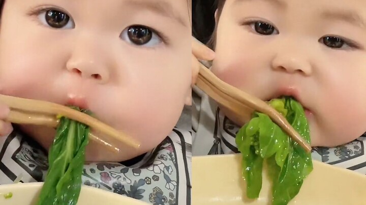 The baby loves the green vegetables grown by grandpa and grandma, munching away like a little bunny 
