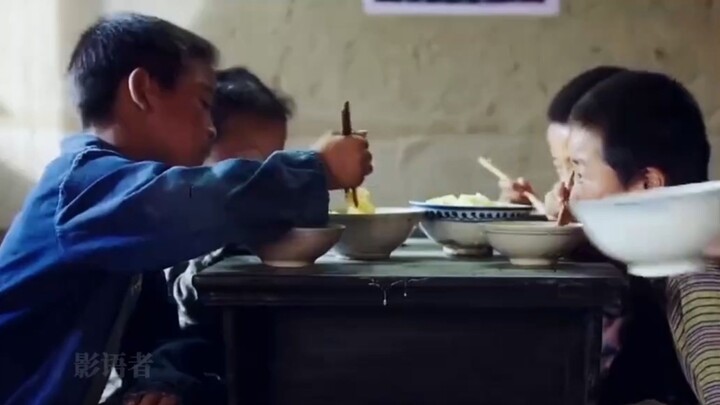 A bowl of rice hits the table, and the boys scramble for it—otherwise, there’s no food left! Watch t