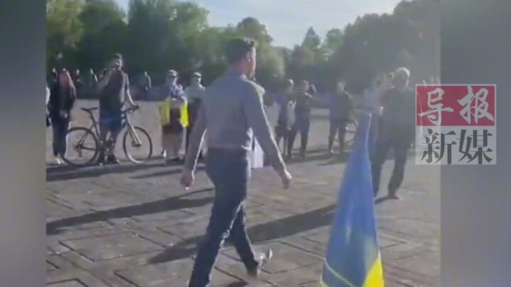 Amid shouts of "fascist," a young man still stepped forward to lay flowers.