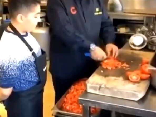The father is very proud of his son's cooking skills