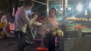 Opening a plastic bag to passers-by eating