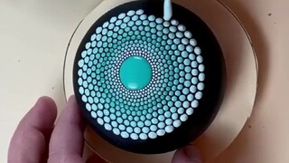 تُركز الشابة على استخدام النقاط لرسم أعمال فنية متنوعة. هل تعتقد أن هذا يبدو جميلاً، أم أنه يُشعرك ب