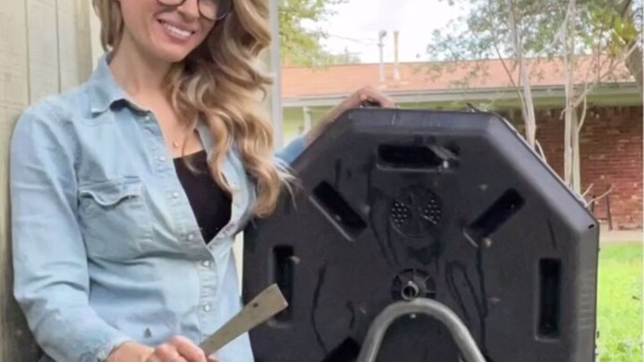 A professional bee rescue lady is moving all the bees and their hive out of the compost bin this tim