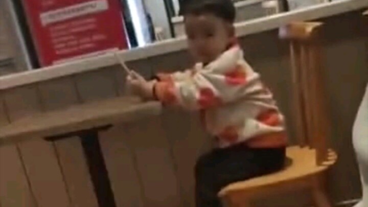 The mobile phone in the child's hand suddenly became boring