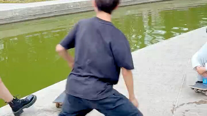 Skateboard grinds the rail and flies over the river—here it comes!