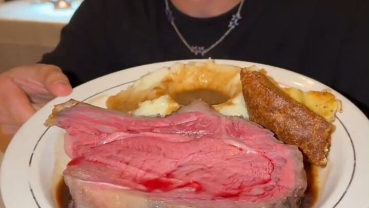 The signature ribeye steak from a century-old Los Angeles restaurant, cooked rare with red juices st