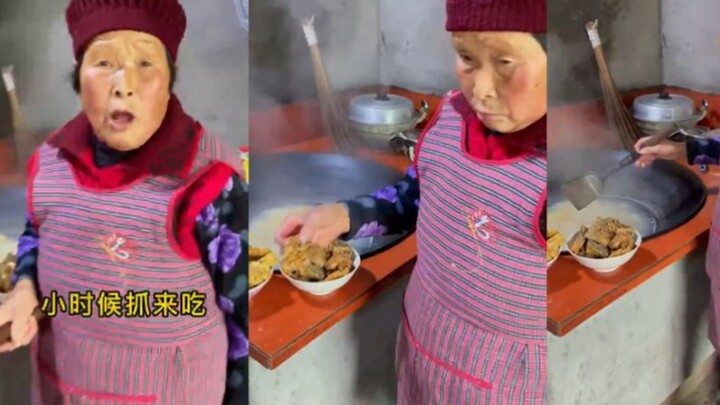 Before the meal started, the young man was eating vegetables in his grandmother's kitchen. His grand