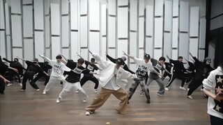 The main dancer stood in the center position and the whole group danced in unison.