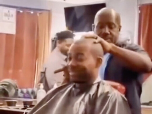 Two black men are in a barber shop, arguing about who is stronger, Whitebeard or Akainu