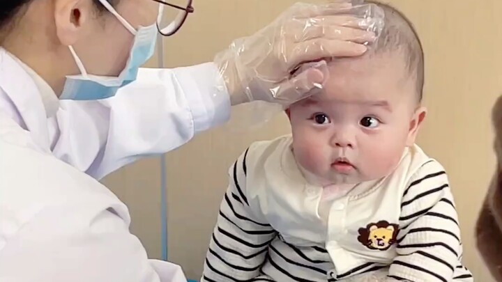 Little baby bravely gets vaccinated during a health checkup—no crying, no fuss!