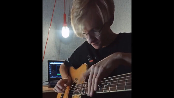 Russian boy performs with his guitar