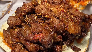 Grilled naan sandwiched with roasted lamb, grilled flatbread stuffed with roasted meat and tendon, a
