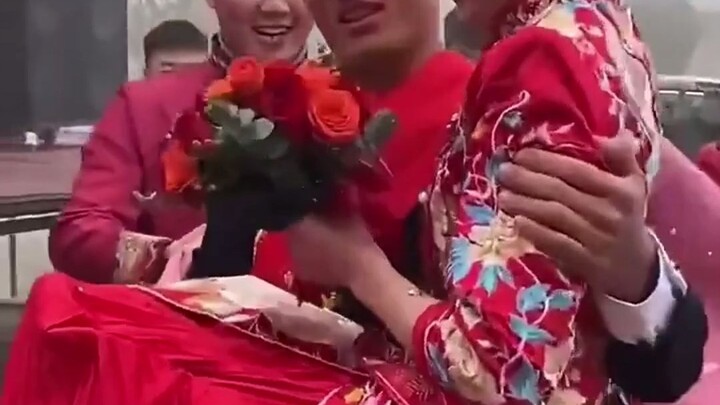 Handsome soldier lifts the bride with one hand while cradling her head with the other!