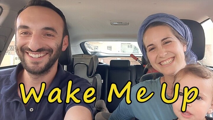A family of three happily sings the famous song "WAKE ME UP" in the car