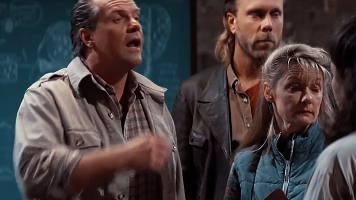 A young man accidentally puts on a pair of sunglasses, only to realize that aliens are all around hi