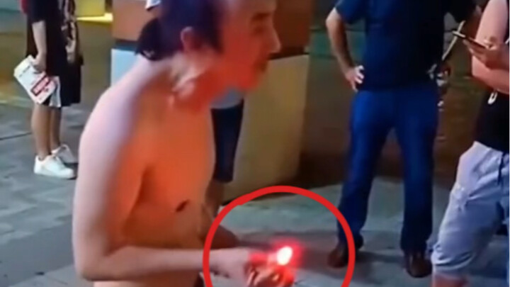 Indian street magician performs a glowing-finger illusion.