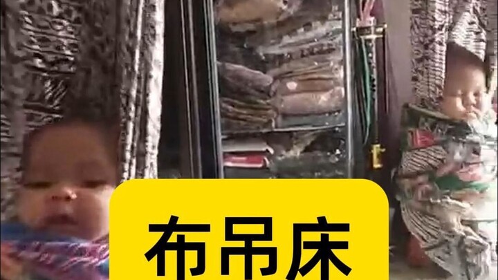 东南亚的哄娃方式“布袋床”