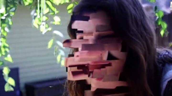 The woman suddenly froze in place, and then her face was broken into pixels, like a bug in a game.