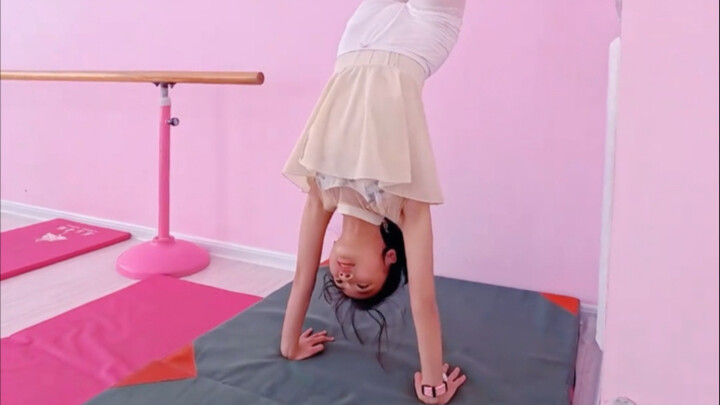 Dance students practicing handstands