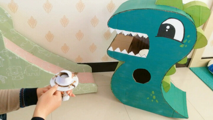DIY a launcher from old cardboard boxes—shoot it straight into a dinosaur’s mouth! It’s super easy t