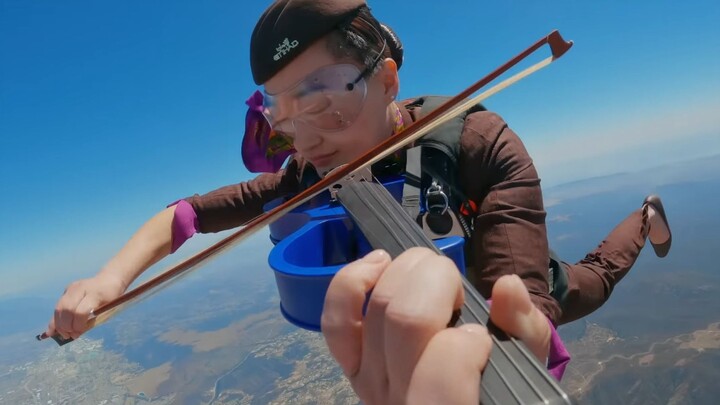 A flight attendant skydiving while playing the Mission Impossible theme song? Is there a more aggres