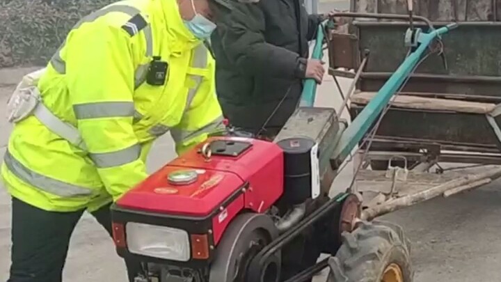 Traffic cop expertly helps old man push a stalled tractor with powerful, smooth moves—knows exactly 