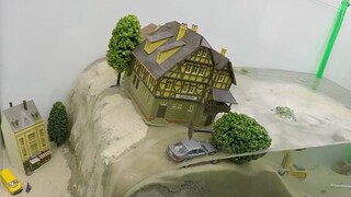 Dam breach experiment, town sinking into water, miniature model