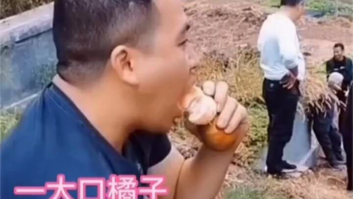 The man had an incredibly calm expression, all to get his friend to eat a sour orange.