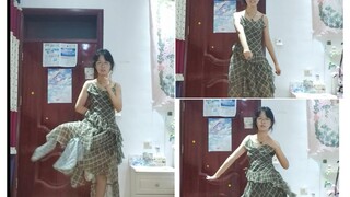 A plain light gauze dress, with grass stalks as flowers on her head...