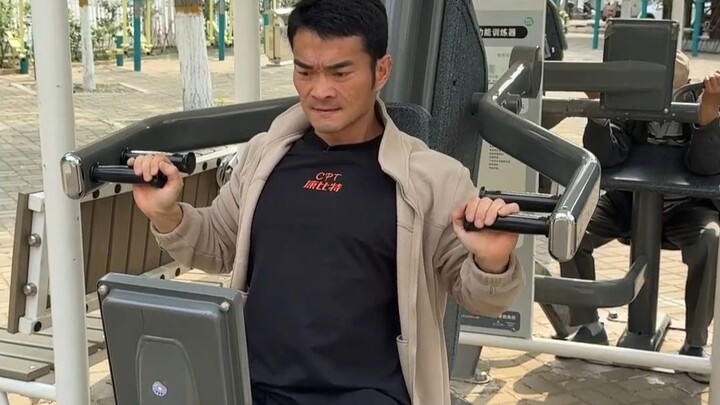Beijing’s outdoor fitness park is fully equipped—only a fitness instructor patrolling the grounds is