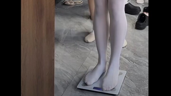 Dance students weigh themselves barefoot