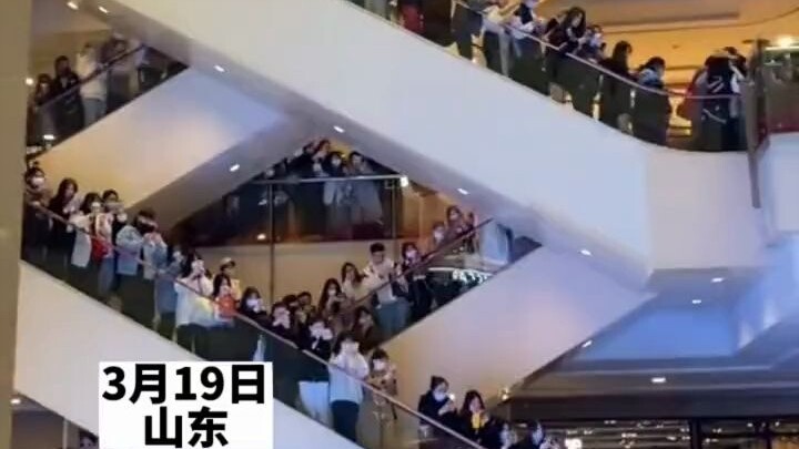 The escalators at the Shanghai event venue were packed with people.