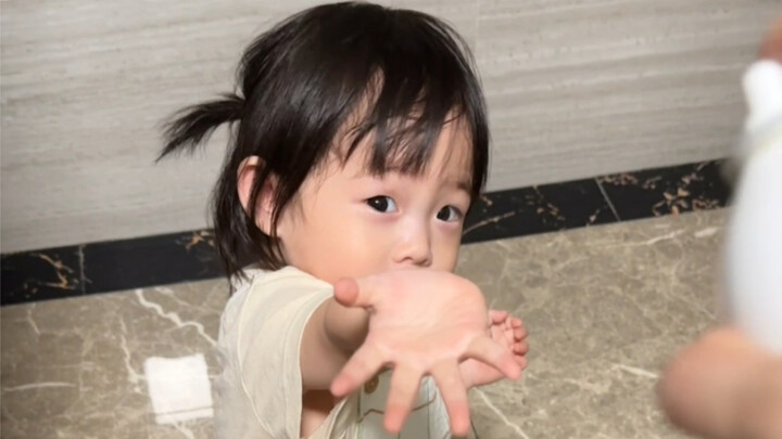 A little girl waiting for her mom to put on makeup
