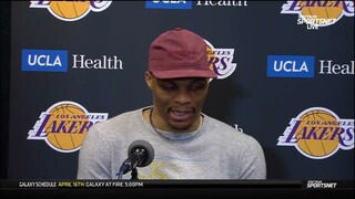 Russell Westbrook makes sure the camera shows the sweater he's wearing.