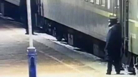 The train attendant skillfully pulled out a bottle.