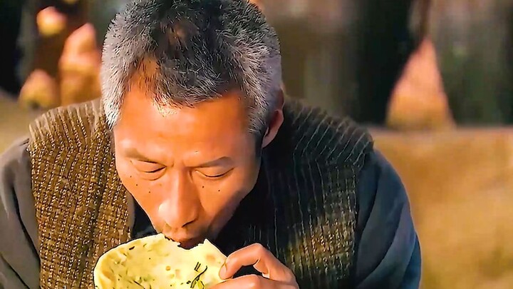 The old man takes just one bite of a hand‑held pancake and already knows next year will surely bring