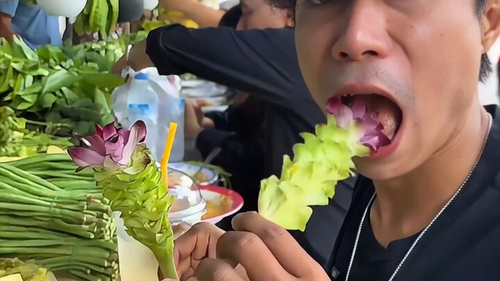 Thai people slurp noodles and even eat various raw greens straight from the roadside planters—busine